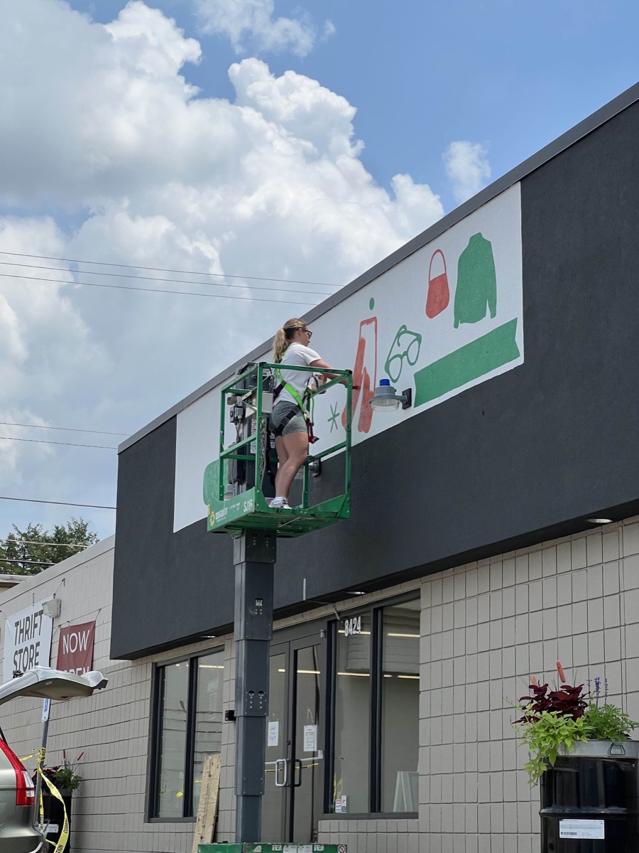 Historical sign-painting scene above the Greater Goods entrance at 8424 Kingston Pike